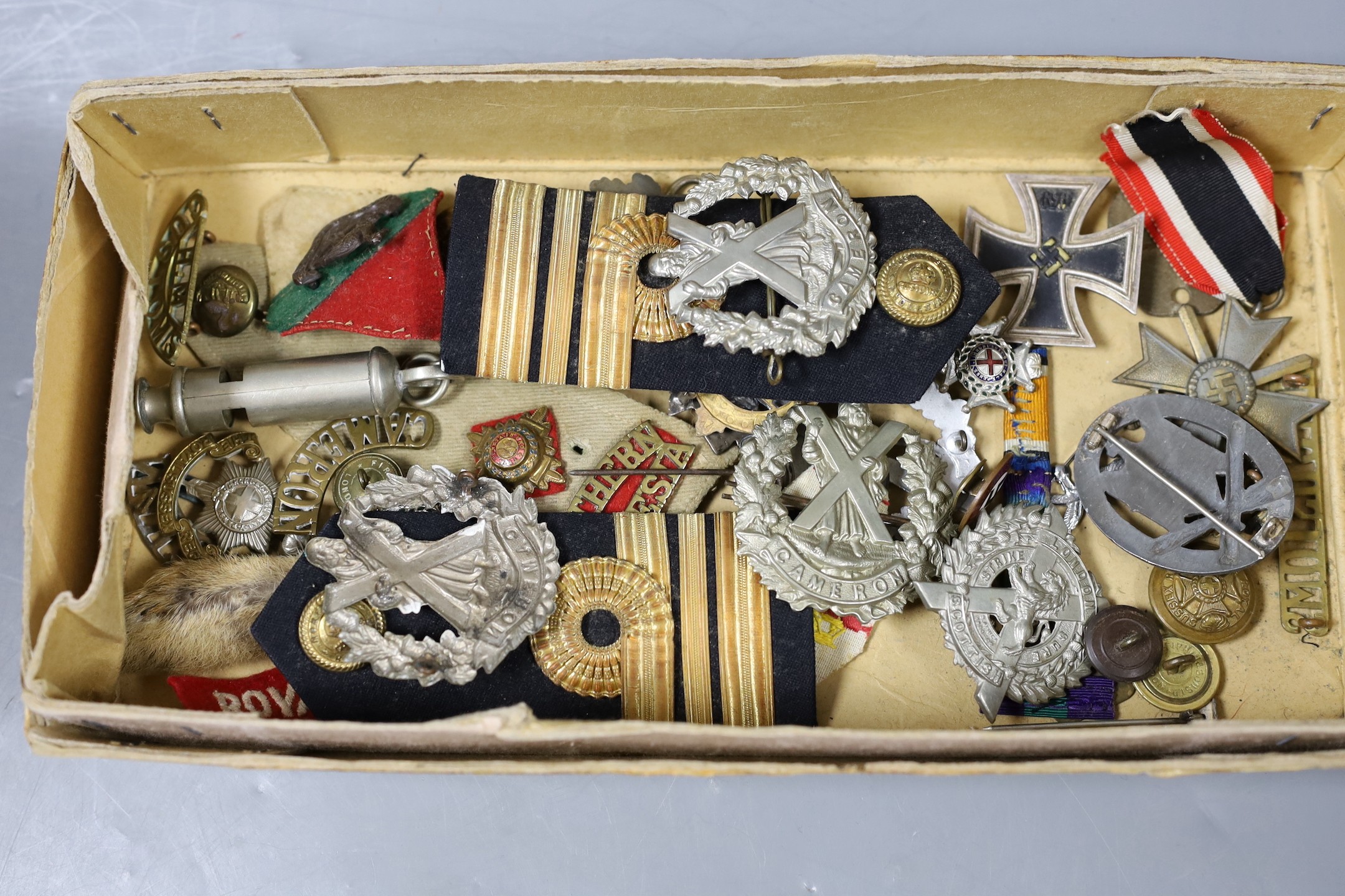 A mixed collection of German Third Reich and other military badges and buttons